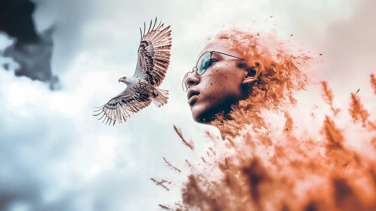 Double exposure of a close-up of a person with glasses blending into clouds and grass