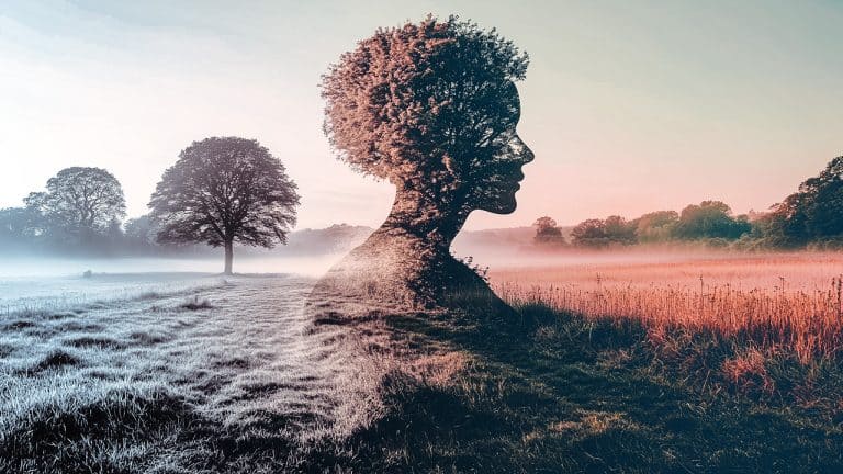 Double exposure of a woman's profile with tree branches forming her hair