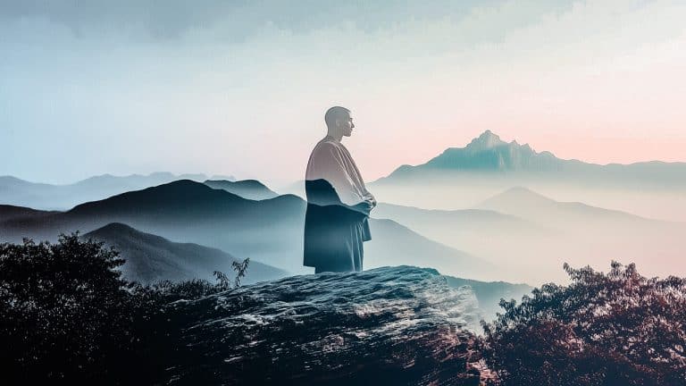 Double exposure of a serene monk standing and a misty mountain landscape: tranquility and mindfulness concept.