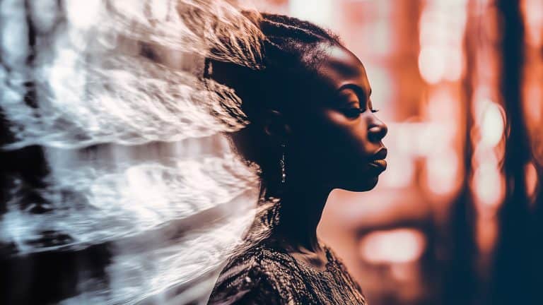 Double exposure of a woman in profile with closed eyes wearing a textured top