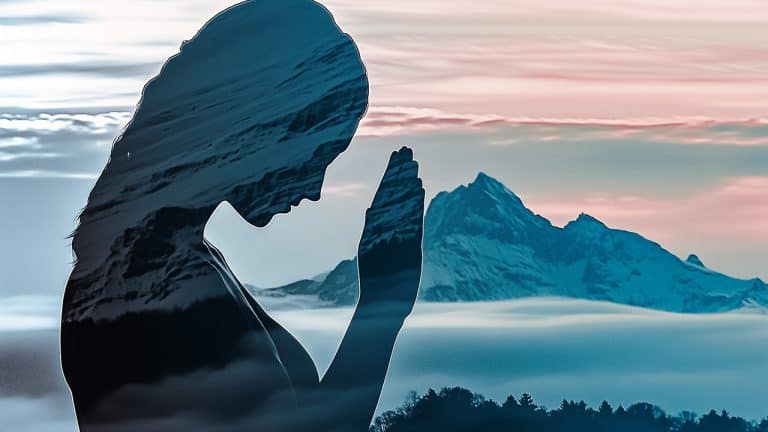 Double exposure of a silhouette of a person in a prayer position and a snowy mountain landscape with clouds: serenity and contemplation concept.