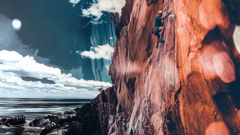 Double exposure of a person rock climbing on a steep cliff and an ocean view with a rocky shoreline under a blue sky: adventure and nature concept.