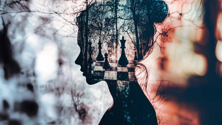 Double exposure of a woman's silhouette with hair tied up