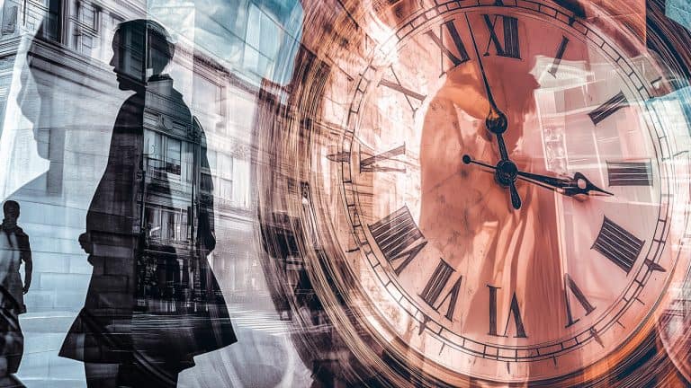 Double exposure of a silhouette of a person walking by a building and a large clock face with Roman numerals: passage of time and urban life concept.