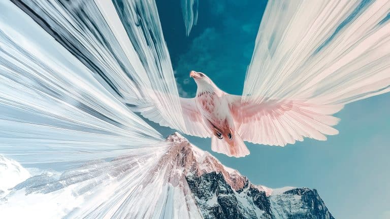 Double exposure of an eagle soaring with wings spread wide and a snowy mountain peak under a clear blue sky: freedom and majesty concept.