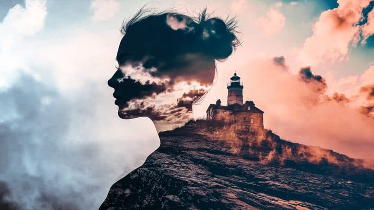 Double exposure of a woman's silhouette filled with clouds and a sunset