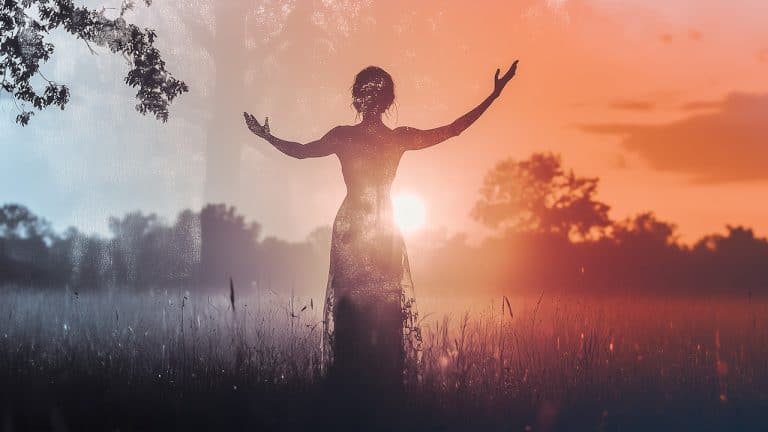 Double exposure of a silhouette of a woman with arms raised in a field