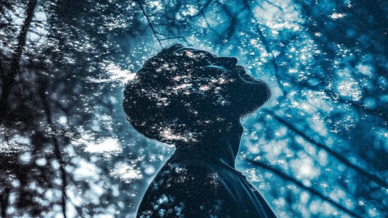 Double exposure of a silhouette of a man looking up and a starry night sky: wonder and introspection concept.