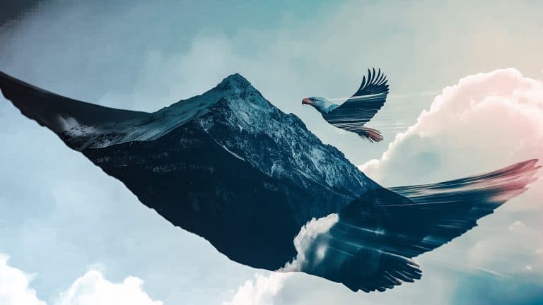 Double exposure of a snow-capped mountain peak and a soaring eagle with wings spread wide: freedom and majesty concept.