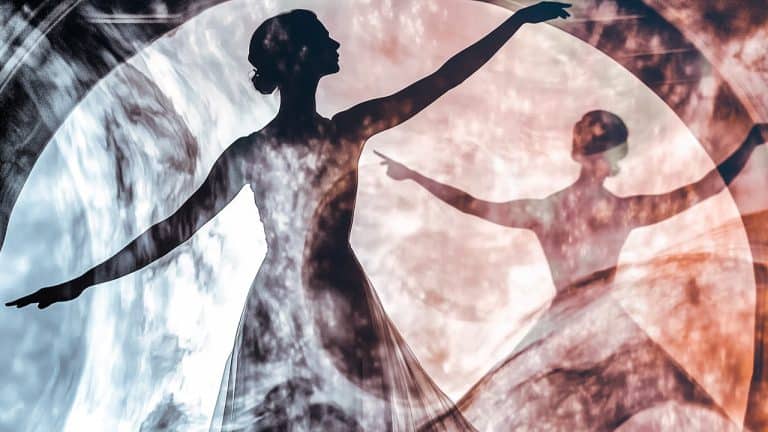 Double exposure of a silhouette of a ballerina with arms gracefully extended