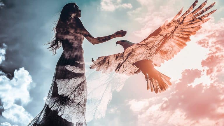 Double exposure of a woman reaching out against a sky background