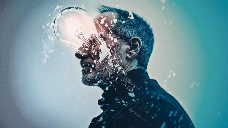 Double exposure of a side profile of a bearded man and an illuminated light bulb: creativity and innovation concept.
